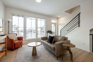 Modern living room with floor to ceiling windows and power blinds